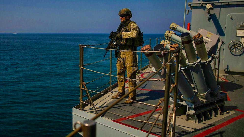 A Turkish army soldier stands guard on one of the two military ships traveling in the Mediterranean. Photo: Emrah Gurel/AP