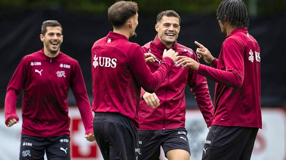 Captain Granit Xhaka (2nd from right) jokes with his teammates in training before the departure to Serbia