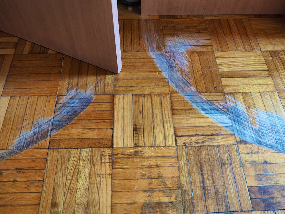 Deep scratches in parquet flooring disturb the eye.