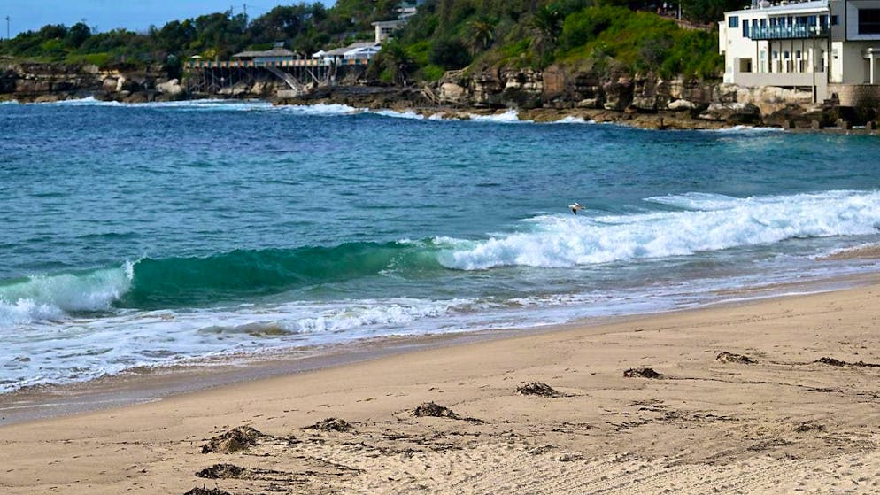 The beach is closed as unknown debris washes up on Coogee Beach in Sydney. Coogee Beach in Sydney's east has been closed after the discovery of "mysterious, black, spherical debris". Photo: Steven Markham/AAP/dpa