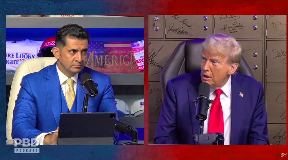 Patrick Bet-David of the PBD Podcast (left) listens intently to Donald Trump's remarks.