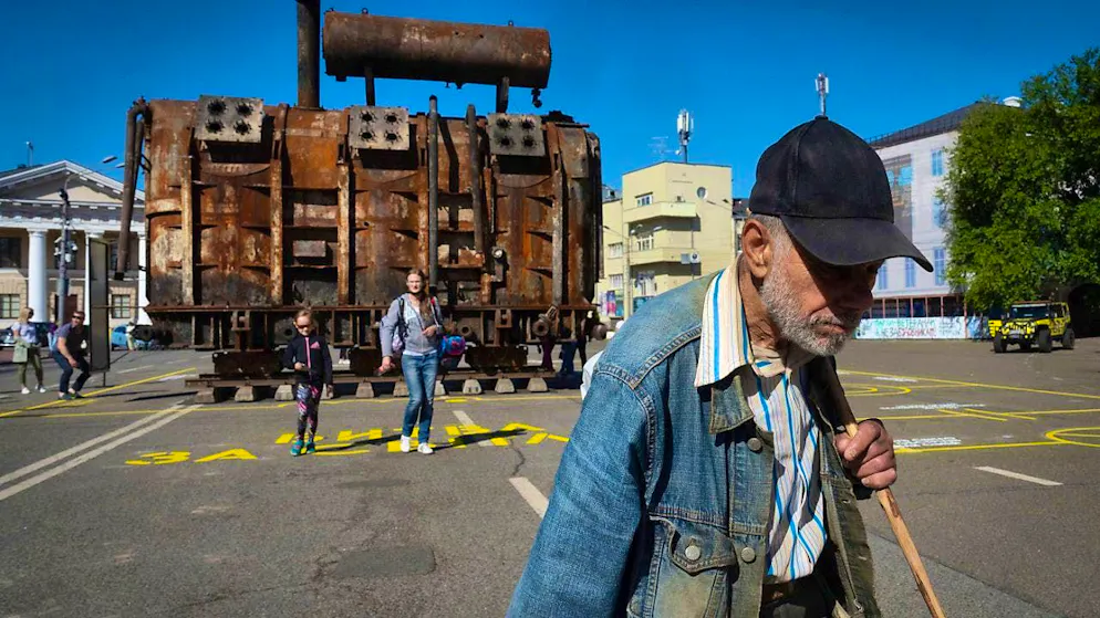 ARCHIVE - A man walks past a burnt power plant that was damaged in a Russian missile attack. Photo: Efrem Lukatsky/AP/dpa