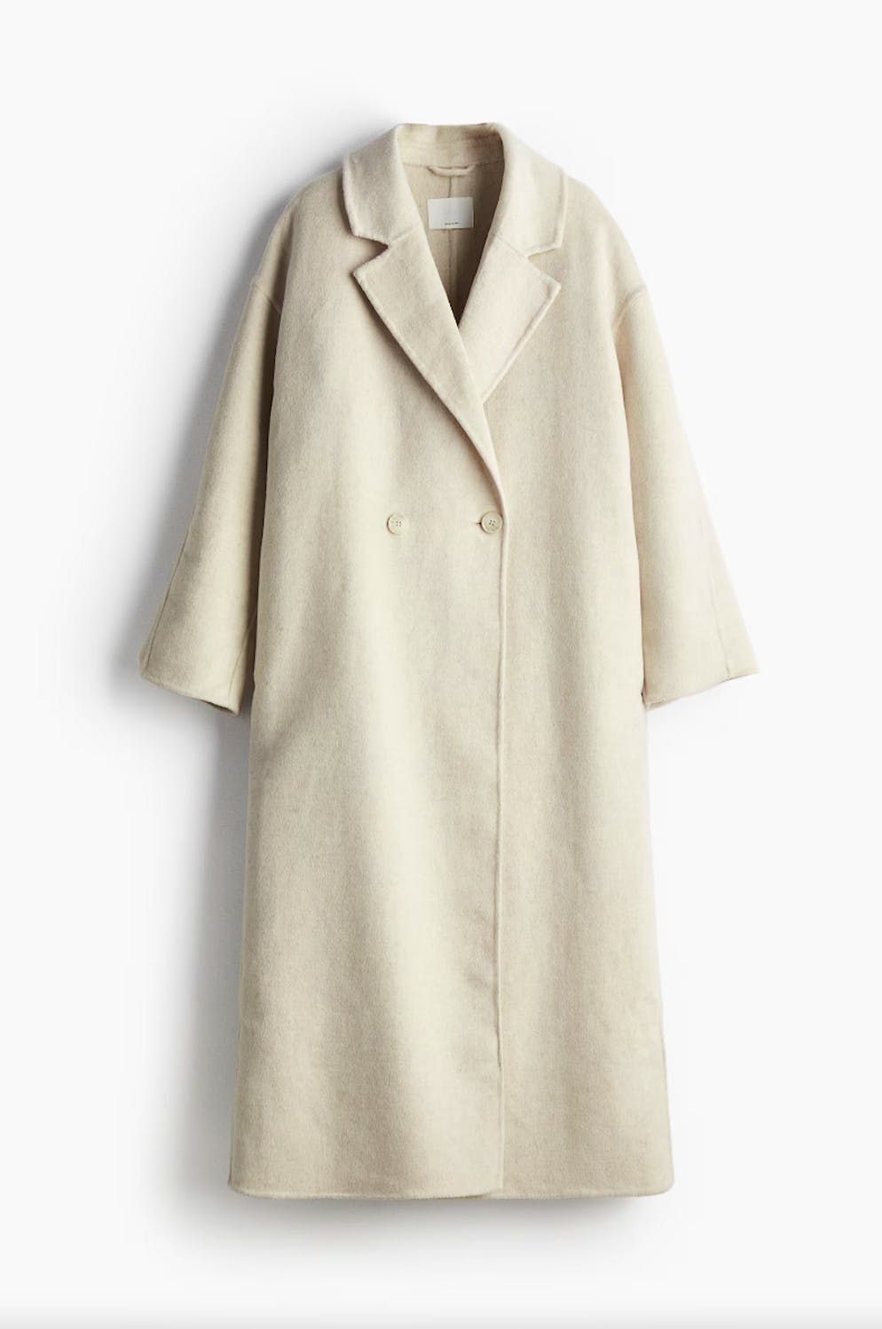 1. Jacken- und Mantel-Trends: Überlänge. Weisser Mantel aus Wollmix in XXL-Länge von H&M für 229 Franken.