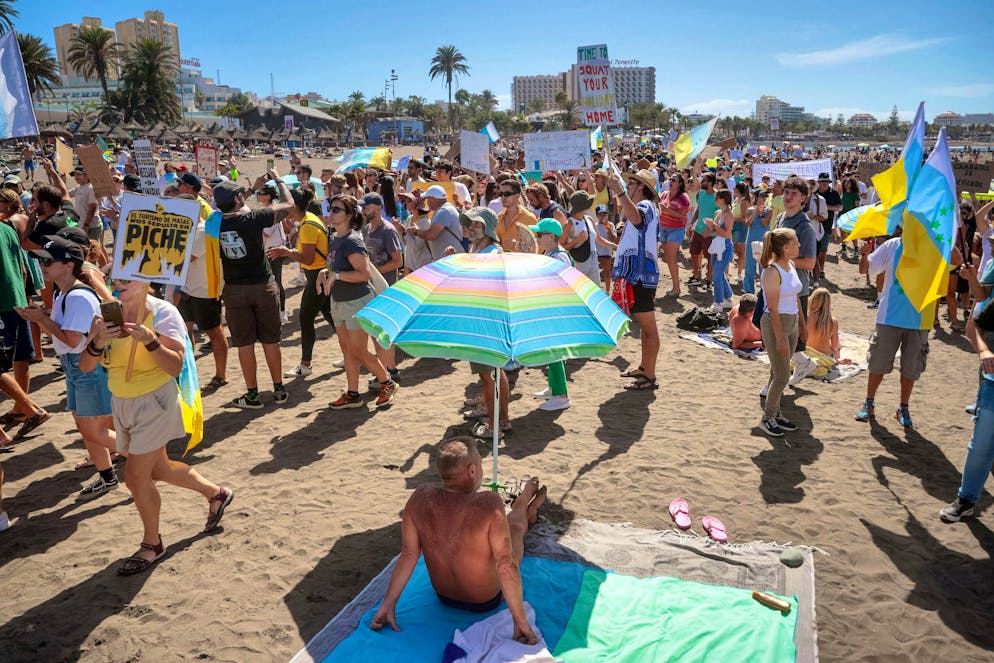 The protesters march through the city directly in front of the tourists on Sunday.