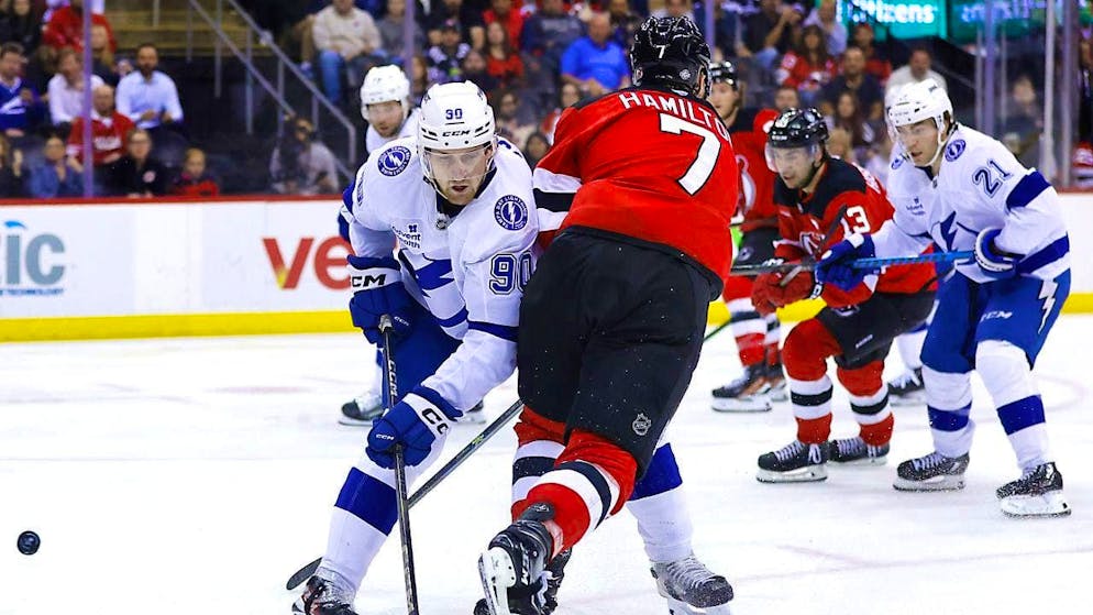 Tampa Bay's Janis Moser (left) keeps the upper hand in a duel with the Swiss trio at the New Jersey Devils.