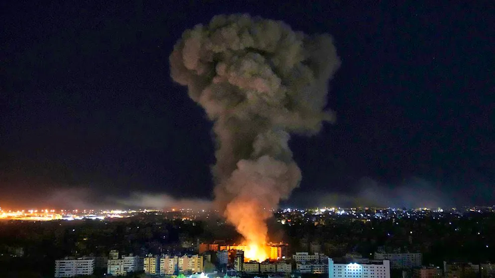 Flames and smoke rise from buildings hit by Israeli airstrikes on Dahiyeh, a southern suburb. Photo: Hussein Malla/AP