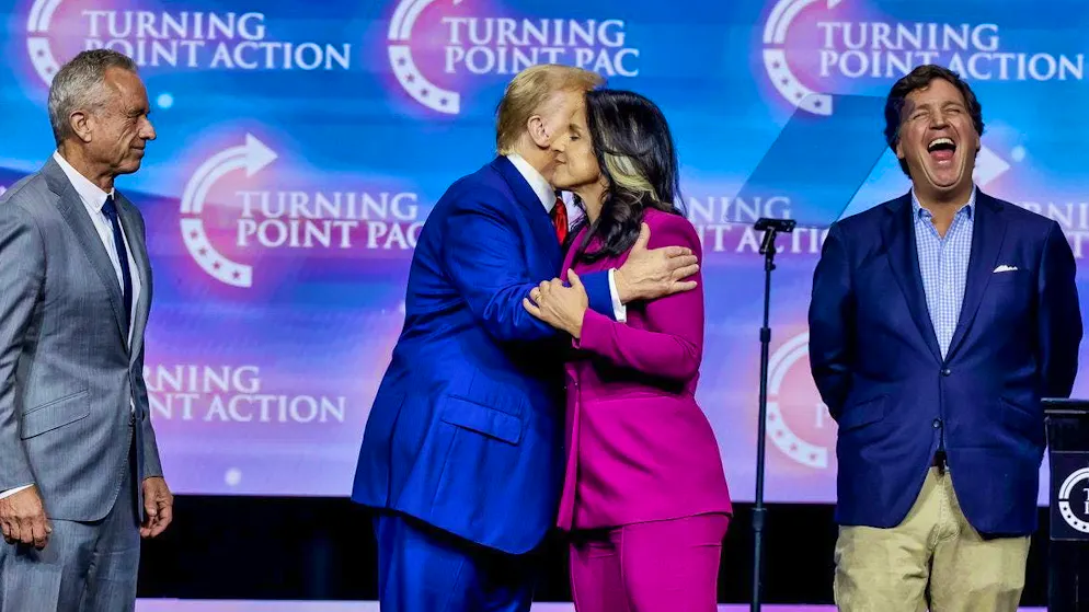 October 23 in Duluth, Georgia: Donald Trump hugs Tulsi Gabbard, Robert F. Kennedy Jr. looks on and Tucker Carlson laughs his head off.