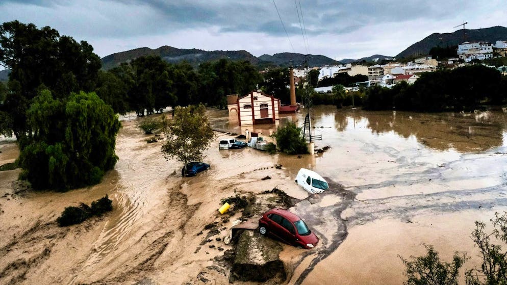 Cars washed away and derailed express train in Spain - Gallery. Cars were washed away in Alora near Malaga.