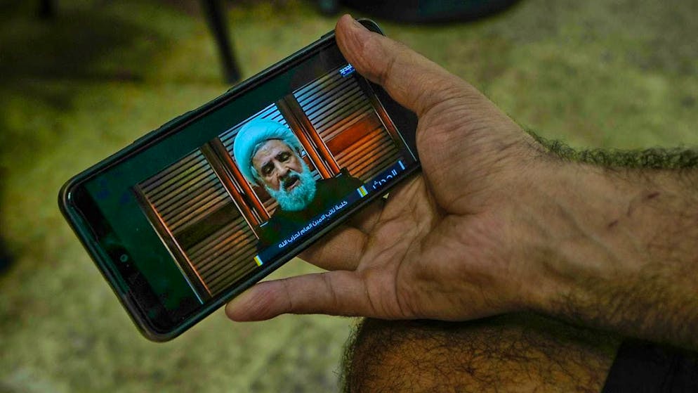 ARCHIVE - A man listens to a speech by Naim Kassim on his cell phone. Photo: Bilal Hussein/AP/dpa
