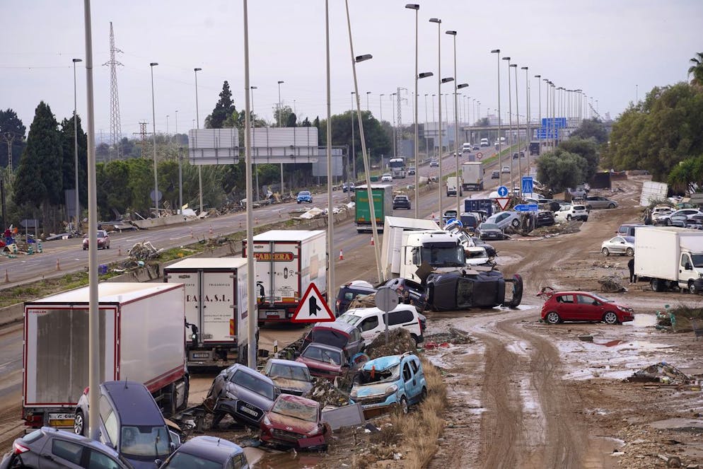 Cars are strewn on the side on a main road after floods in Valencia, Spain, Friday, Nov. 1, 2024. (AP Photo/Alberto Saiz)