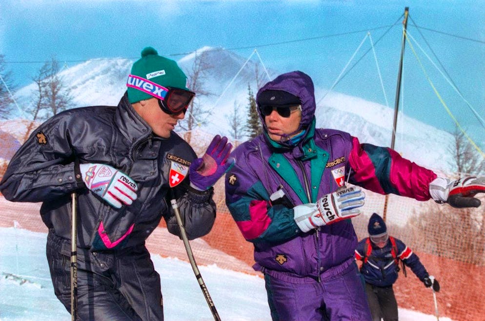 Pirmin Zurbriggen - the biggest ski star of the 80s. Iron Karl and his biggest star: Karl Frehsner, right, coach of the Swiss national ski team, gives Pirmin Zurbriggen, left, advice before the downhill race at the 1988 Winter Olympics in Calgary. Zurbriggen goes on to win the gold medal. (KEYSTONE/Thomas Studhalter)