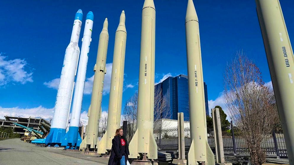 ARCHIVE - A woman walks past Iranian-made missiles and satellite launchers on permanent display in a recreational area in northern Tehran. Photo: Vahid Salemi/AP/dpa