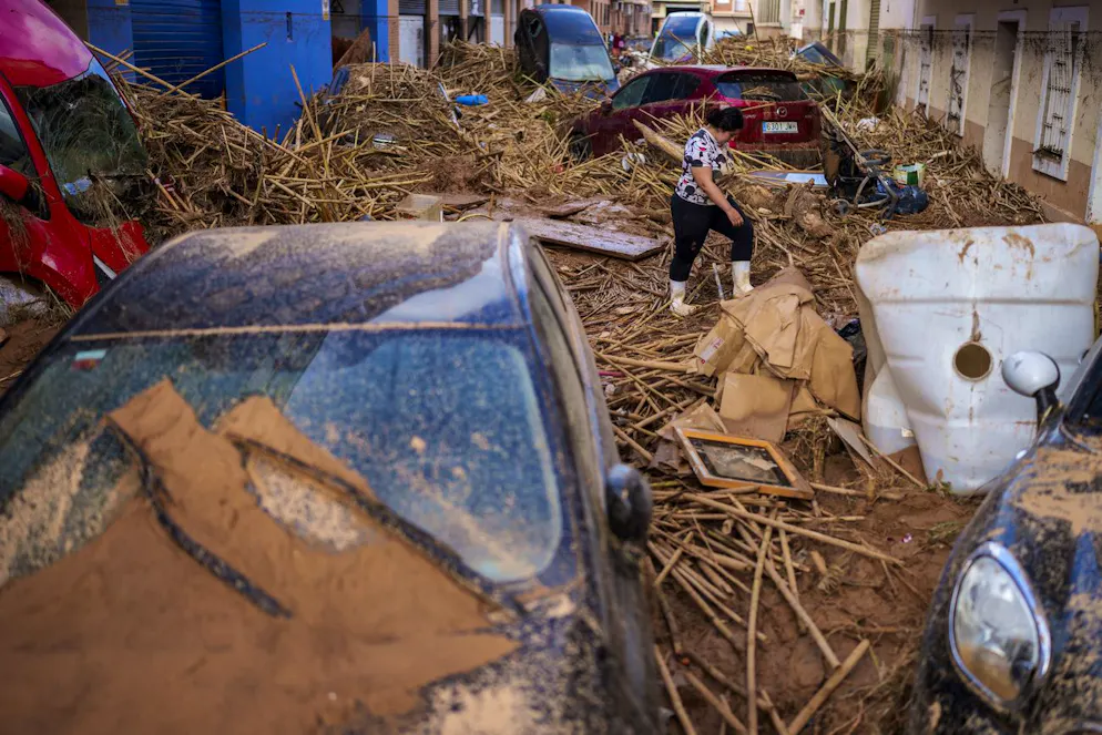 Una donna cammina in una strada colpita dalle inondazioni a Paiporta, una città della regione di Valencia, in Spagna, sabato 2 novembre 2024. 