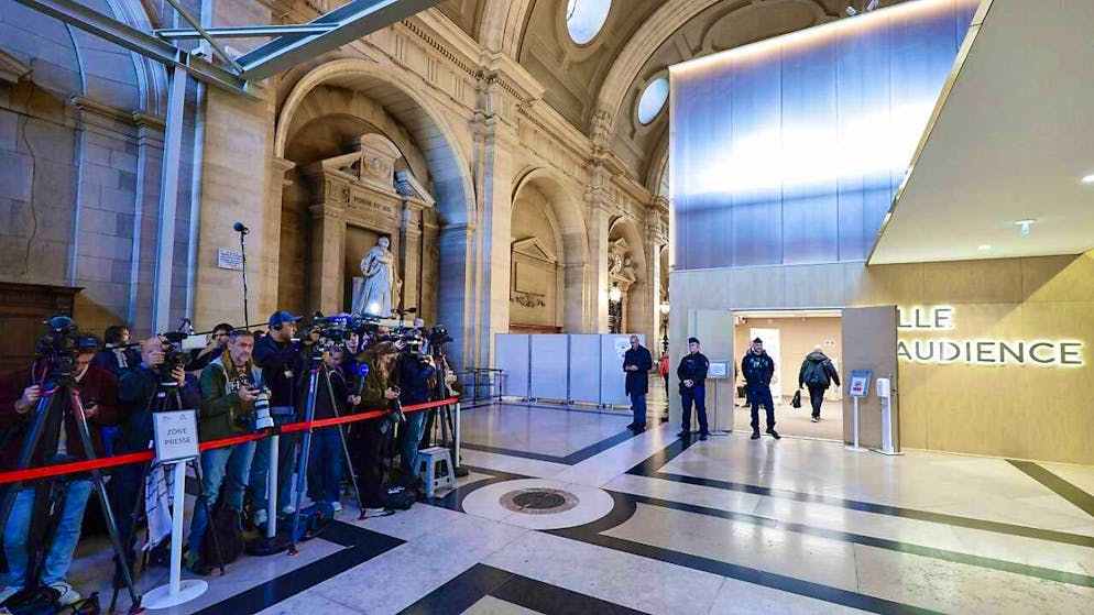 Members of the press wait outside the courtroom where eight adults are being tried for the murder of teacher Samuel Paty at the Paris Special Court. Photo: Stephane De Sakutin/AFP/dpa