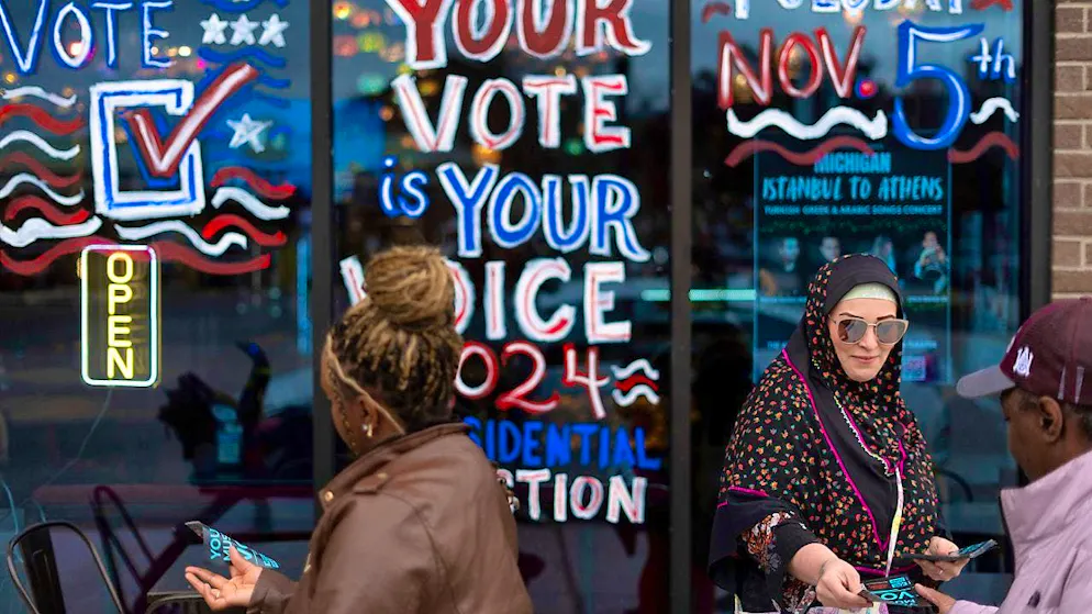 A volunteer distributes leaflets during the US election campaign. Photo: David Goldman/AP