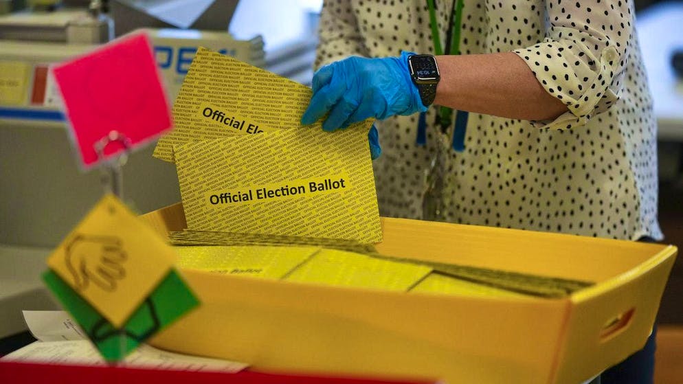 Trump or Harris? Election day in the USA. Poll workers count postal votes.
