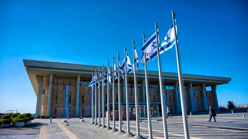 ARCHIVE - Israeli flags fly in front of the Knesset, the unicameral parliament of the State of Israel. Photo: Christophe Gateau/dpa