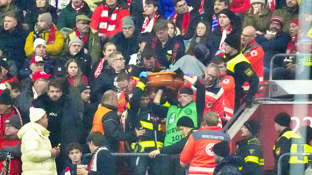 Paramedics carry Romain Jean from the stands. A short time later, he died on the way to hospital.