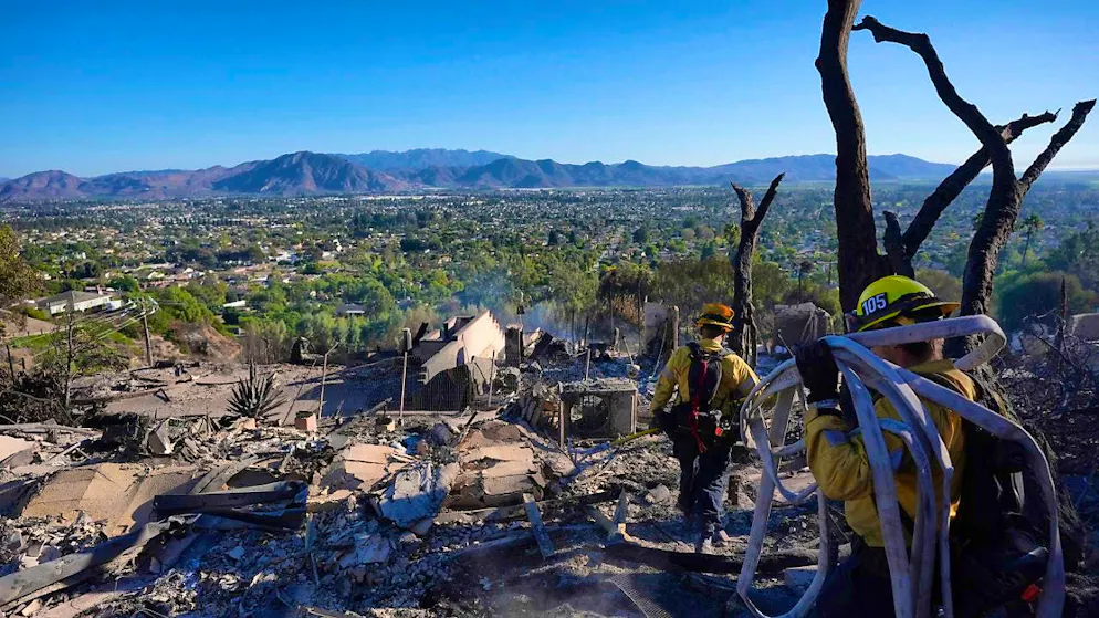 Firefighters work in a house destroyed by the Mountain Fire. Photo: Jae C. Hong/AP/dpa