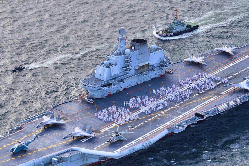 "Hello Hong Kong" is written on the deck of the Liaoning, Beijing's newest aircraft carrier, by Chinese navy soldiers.