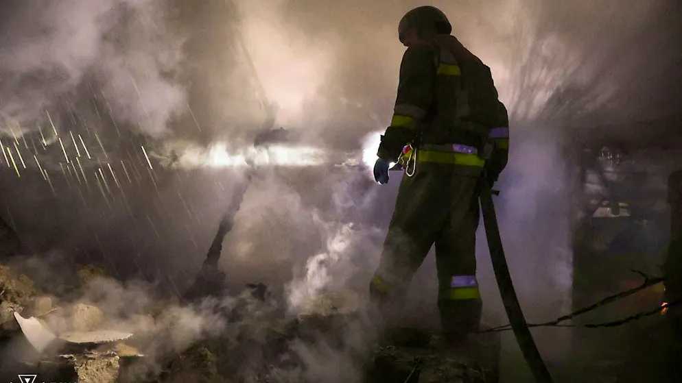 HANDOUT - In this picture provided by Ukraine's Civil Defense, a firefighter works at the site of a Russian attack on a residential area. Photo: Ukrainian Civil Defense/AP/dpa - ATTENTION: For editorial use only and only with full attribution of the above credit