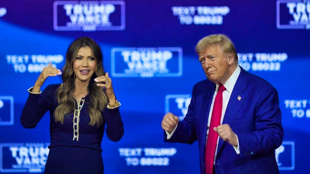 Donald Trump (r.) and the governor of the state of South Dakota, Kristi Noem, dance to the song "Y.M.C.A." at a campaign event on a stage in Pennsylvania. (October 14, 2024)