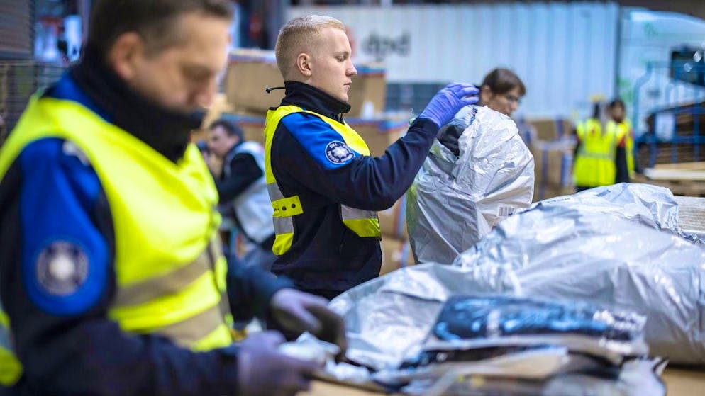 Employees of the Federal Office for Customs and Border Security (FOCBS) open parcels from abroad during a priority inspection in Buchs ZH on Tuesday, November 12, 2024.