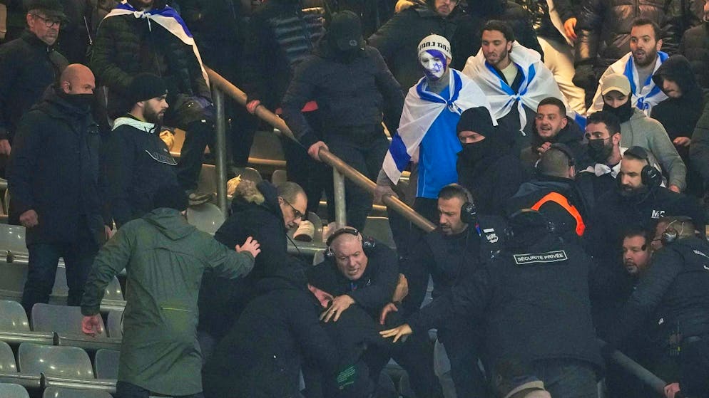 Scuffles break out in the stadium during the first half.