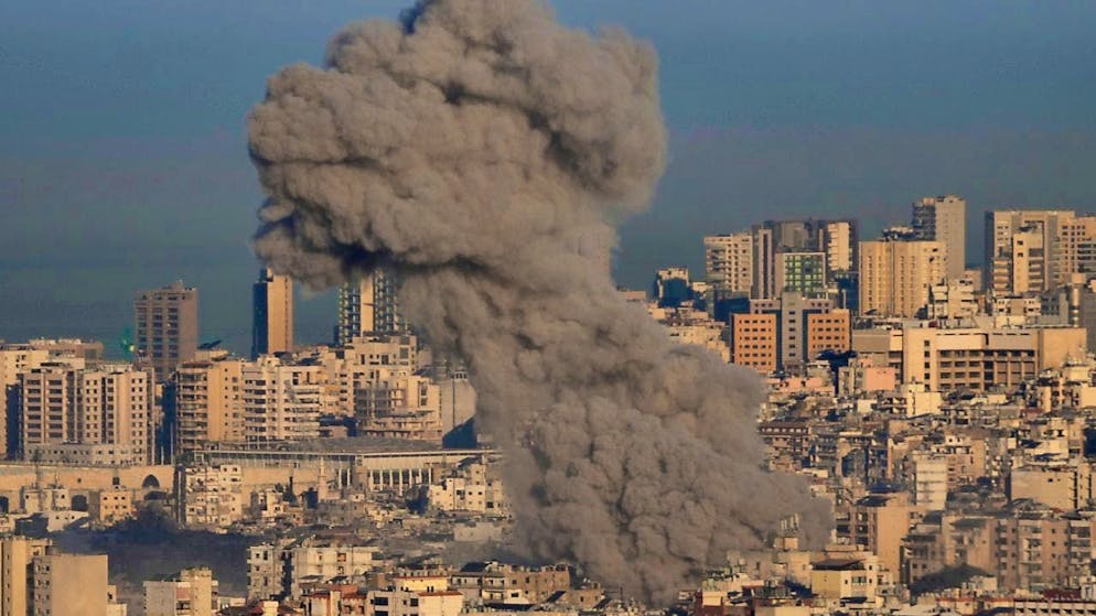 Smoke rises between buildings after an Israeli airstrike in Dahieh, a southern suburb of Beirut. Photo: Hussein Malla/AP/dpa