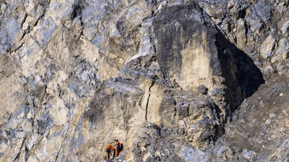 Due specialisti hanno installato dei prismi riflettori sul pendio che sovrasta Brienz (GR)