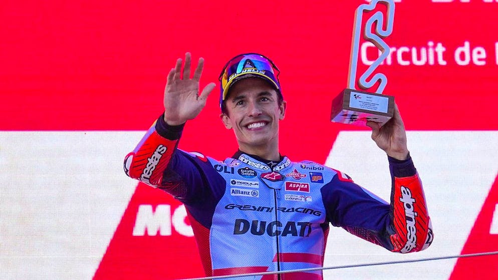 Marc Marquez waves from the podium at the end of the season in Montmelo