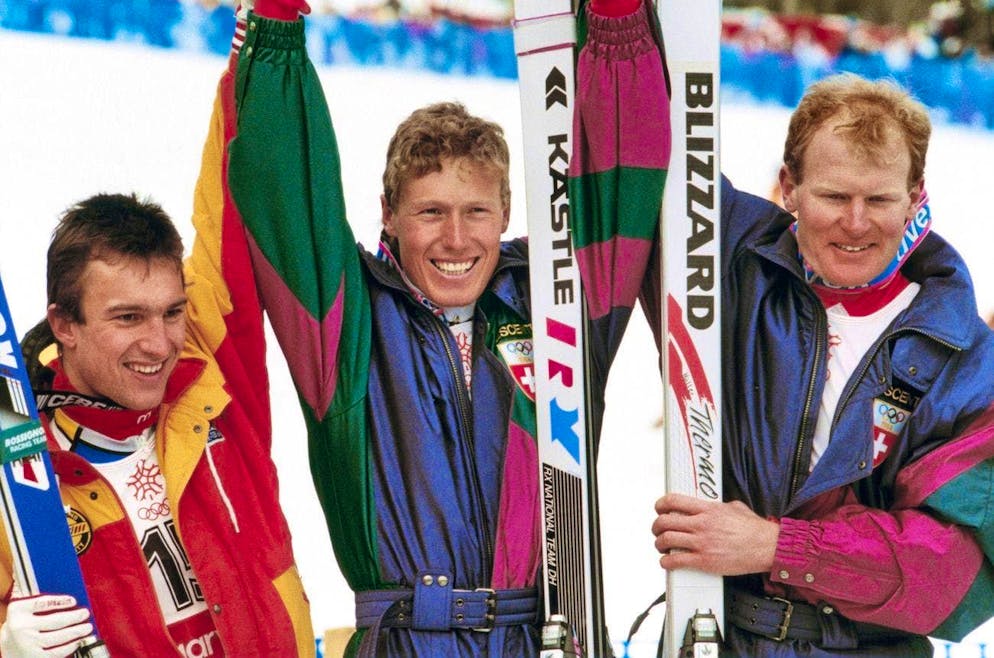 Switzerland's Pirmin Zurbriggen, center, gold, Peter Müller, right, silver, and France's Franck Piccard, left, bronze, celebrate their medals in the downhill at the 1988 Winter Olympics in Calgary. (KEYSTONE/Thomas Studhalter)