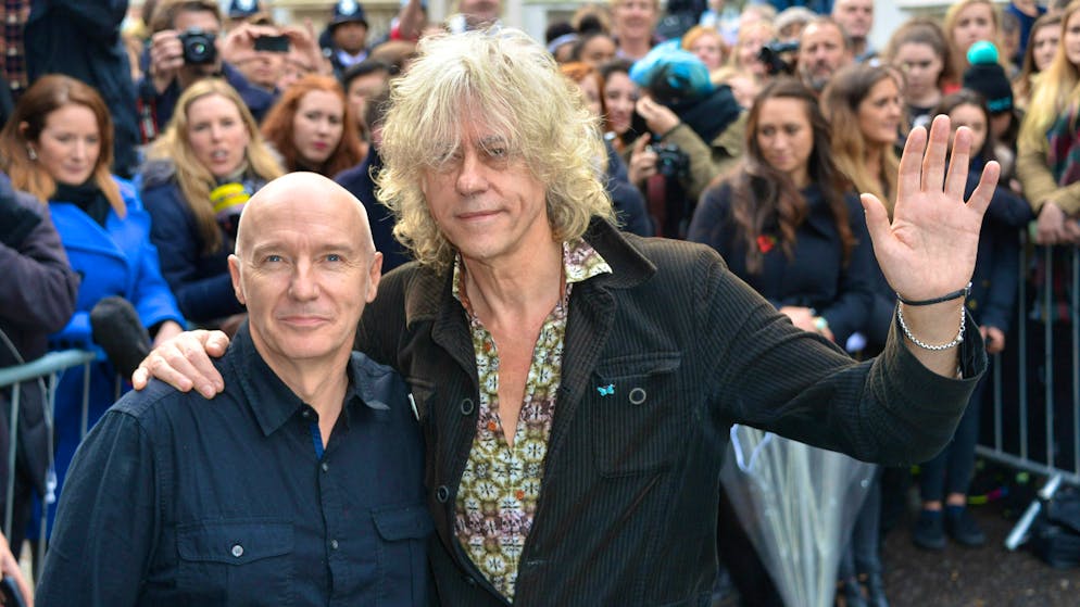 The re-release of "Do You They Know It's Christmas?" is facing criticism on its 40th anniversary: the song by Midge Ure and Bob Geldof (right) is accused of racism.