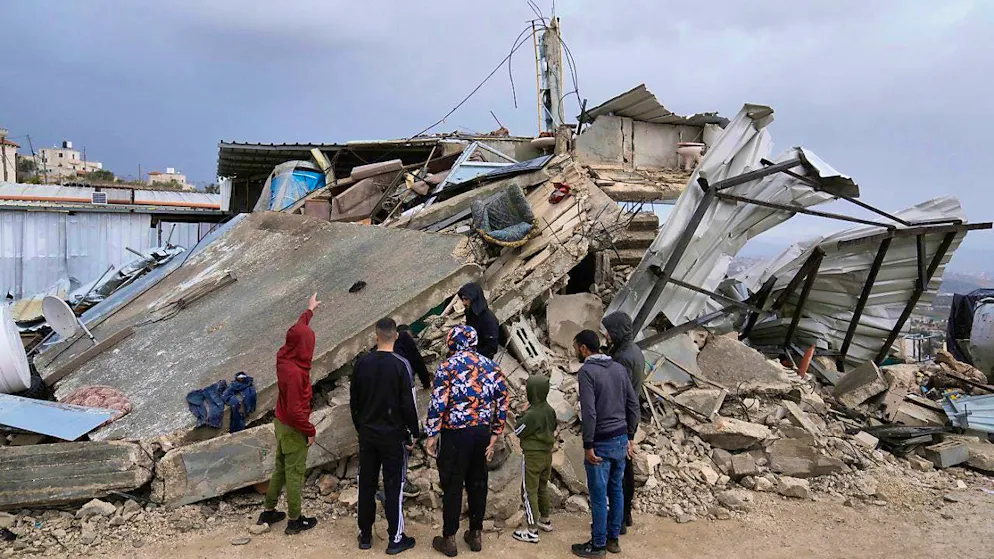 Palestinians inspect the rubble after an Israeli raid in the city. Photo: Majdi Mohammed/AP