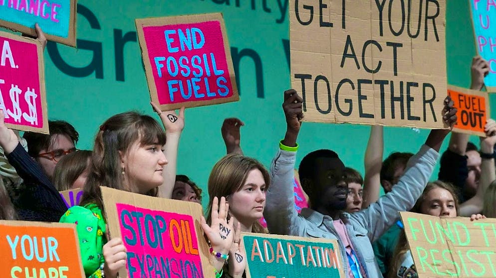 Activists take part in a demonstration against fossil fuels at the UN climate summit COP29. Photo: Peter Dejong/AP