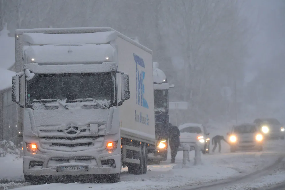 Two articulated lorries are stuck in snow, in Beaumont-les-Autels, central France, on November 21, 2024 as the first flakes of storm Caetano fell in France, where 54 departments are on "orange alert" for snow, ice and wind. -  (Photo by JEAN-FRANCOIS MONIER / AFP)