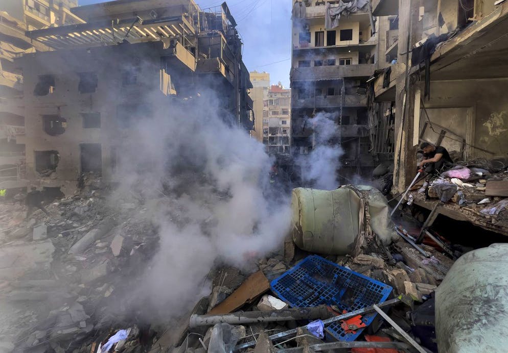 A firefighter extinguishes fire at the site of an Israeli airstrike that hit central Beirut, Lebanon, Saturday, Nov. 23, 2024. (AP Photo/Hussein Malla)