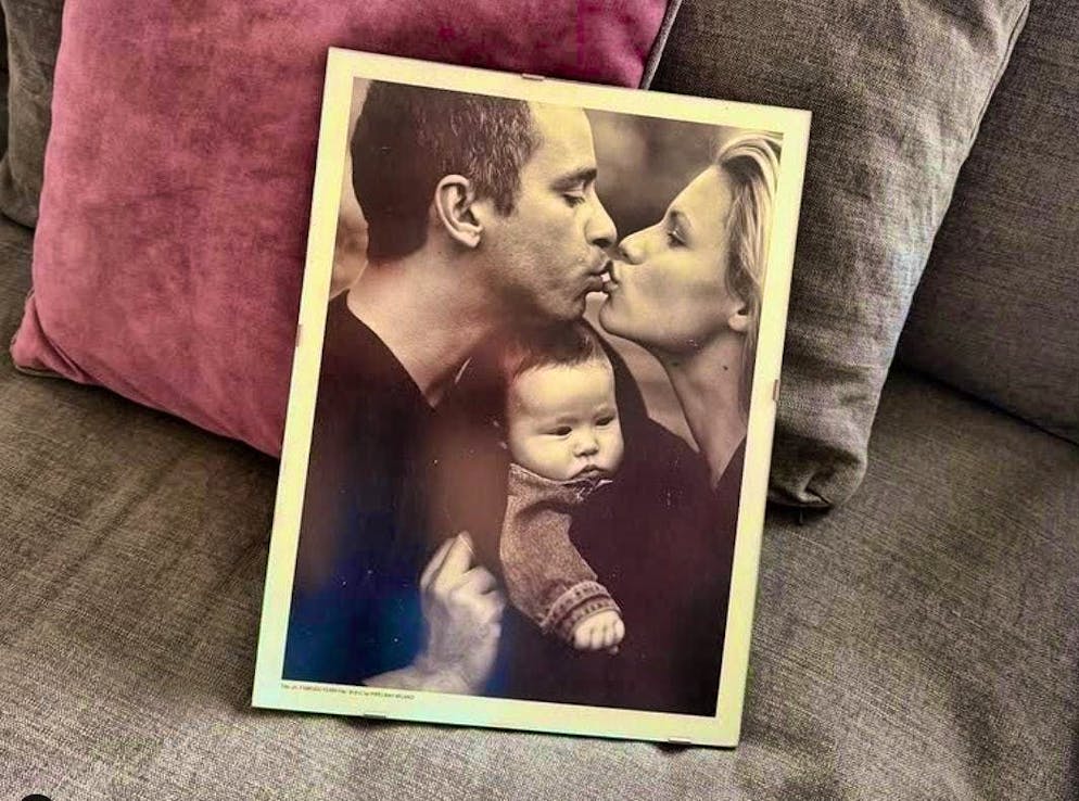 Eros and Michelle in a sweet kiss - with their daughter Aurora in the middle.