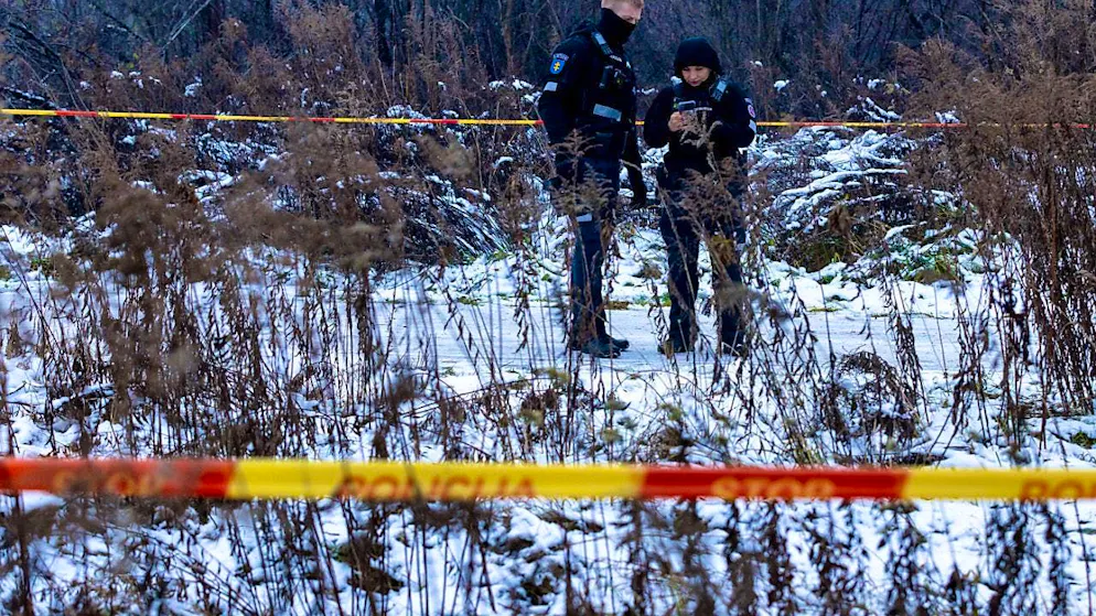 Police officers guard the area of the plane crash. Photo: Mindaugas Kulbis/AP