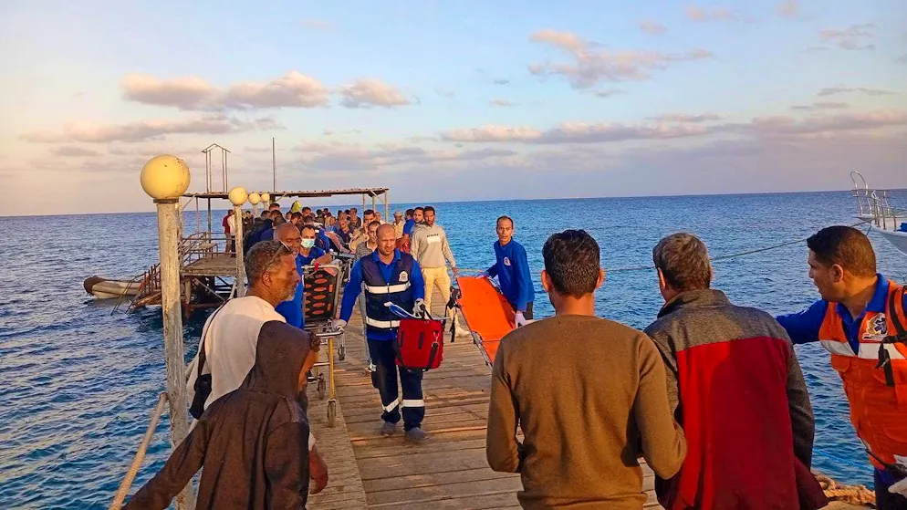 Paramedics and other people wait on a jetty on the Red Sea for survivors of the boat accident. (November 25, 2024)