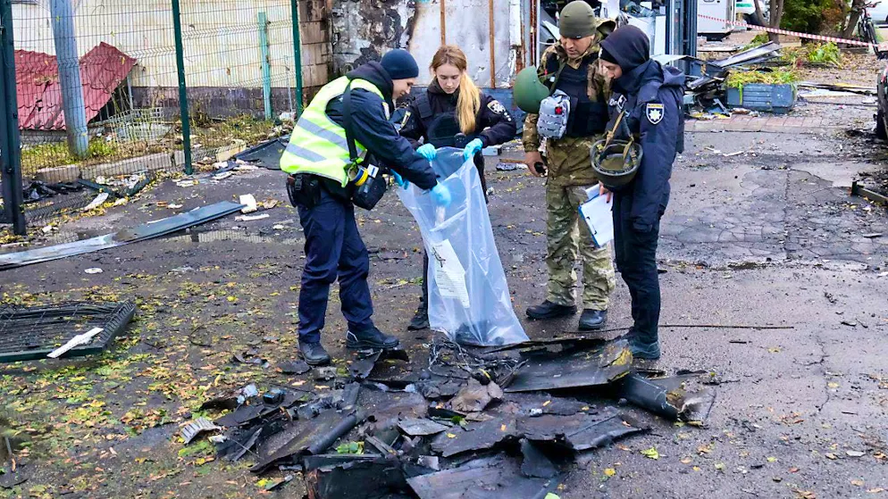 ARCHIVE - Law enforcement officers pick up the fragments of a Russian drone after a Russian drone attack. Photo: --/Ukrinform/dpa