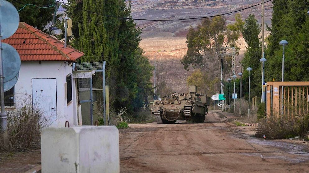 An Israeli army armored vehicle drives into the agricultural settlement of Avivim on the Lebanese border in the Upper Galilee. Photo: Ohad Zwigenberg/AP