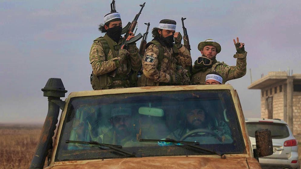 Syrian opposition fighters drive on a truck through Talhiya in the Idlib region, Syria. Photo: Ghaith Alsayed/AP/dpa
