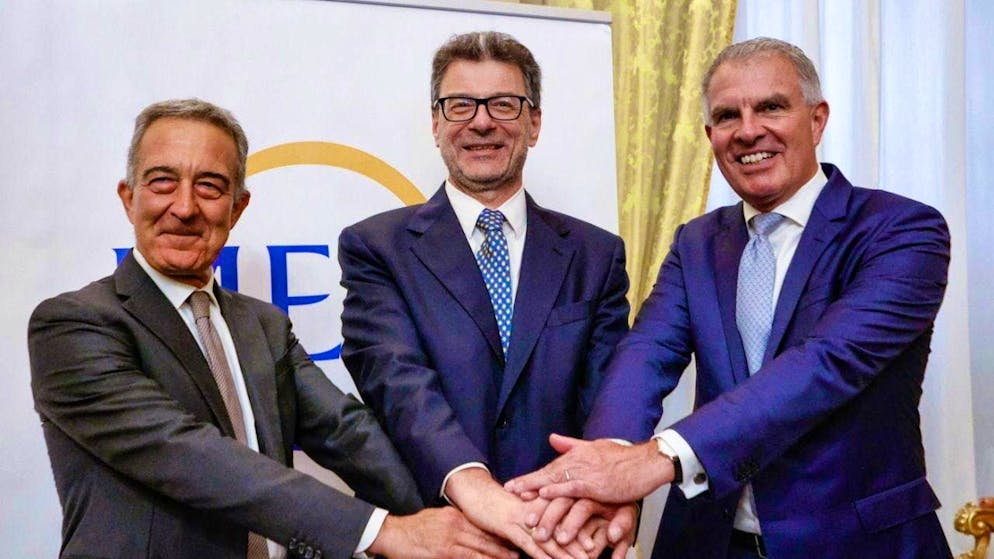 The President of ITA Airways, Antonino Turicchi, Italy's Minister of Economy Giancarlo Giorgetti and Lufthansa CEO Carsten Spohr (from left) shake hands during a press conference on the merger of ITA Airways and Lufthansa in Rome.