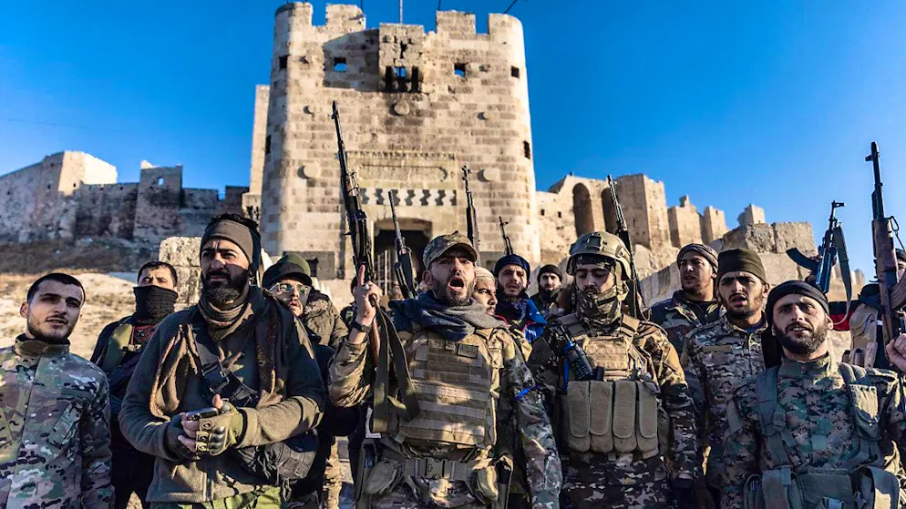 Members of the armed Syrian opposition forces stand in front of the ancient castle of Aleppo