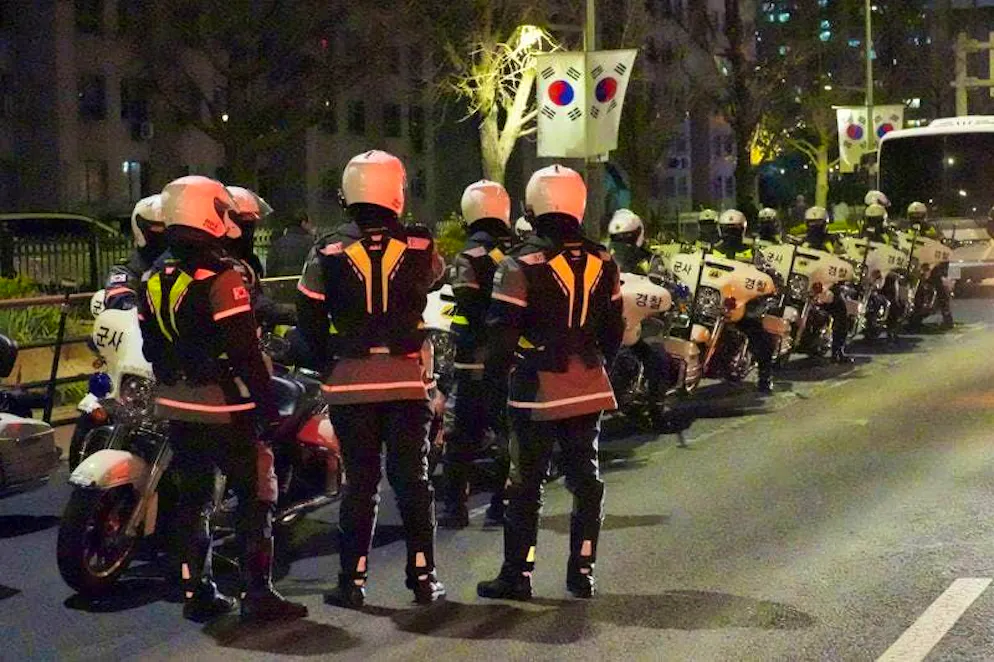 Military police officers stand in front of the National Assembly.