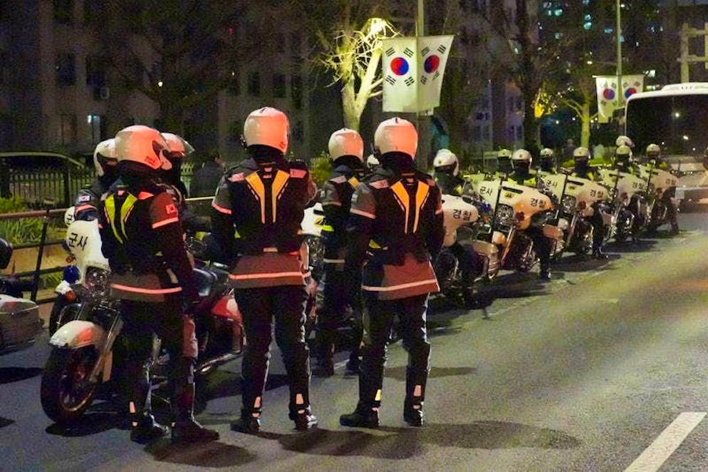 Military police officers stand in front of the National Assembly.