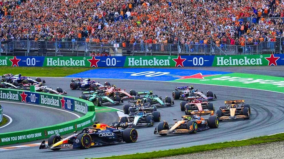 Max Verstappen leads the field in front of the orange wall in Zandvoort.