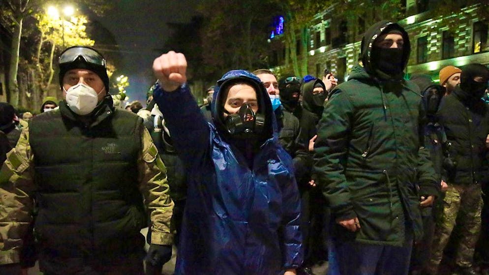 Protesters stand in front of police during a rally against the government's decision to suspend negotiations on joining the European Union, in Tbilisi, Georgia, early Wednesday. Photo: Zurab Tsertsvadze/AP/dpa