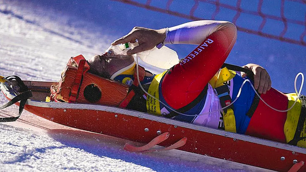 Arnaud Boisset holds a respirator mask to his face on the rescue sled.